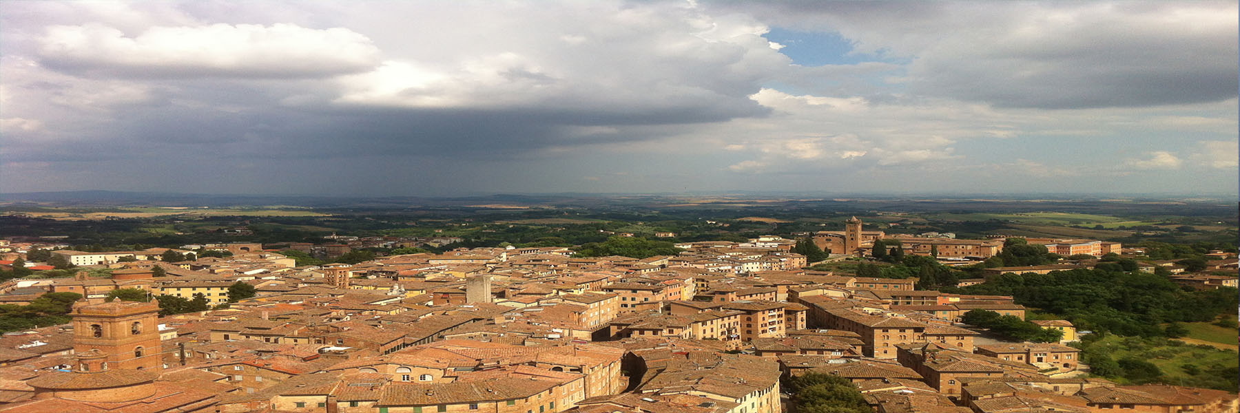 Panoramic view overlooking small city and countryside.